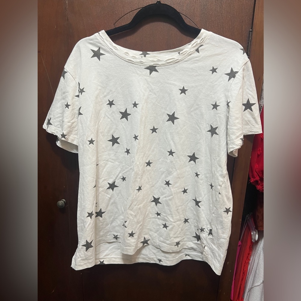 white shirts with black stars and is distressed at the collar.